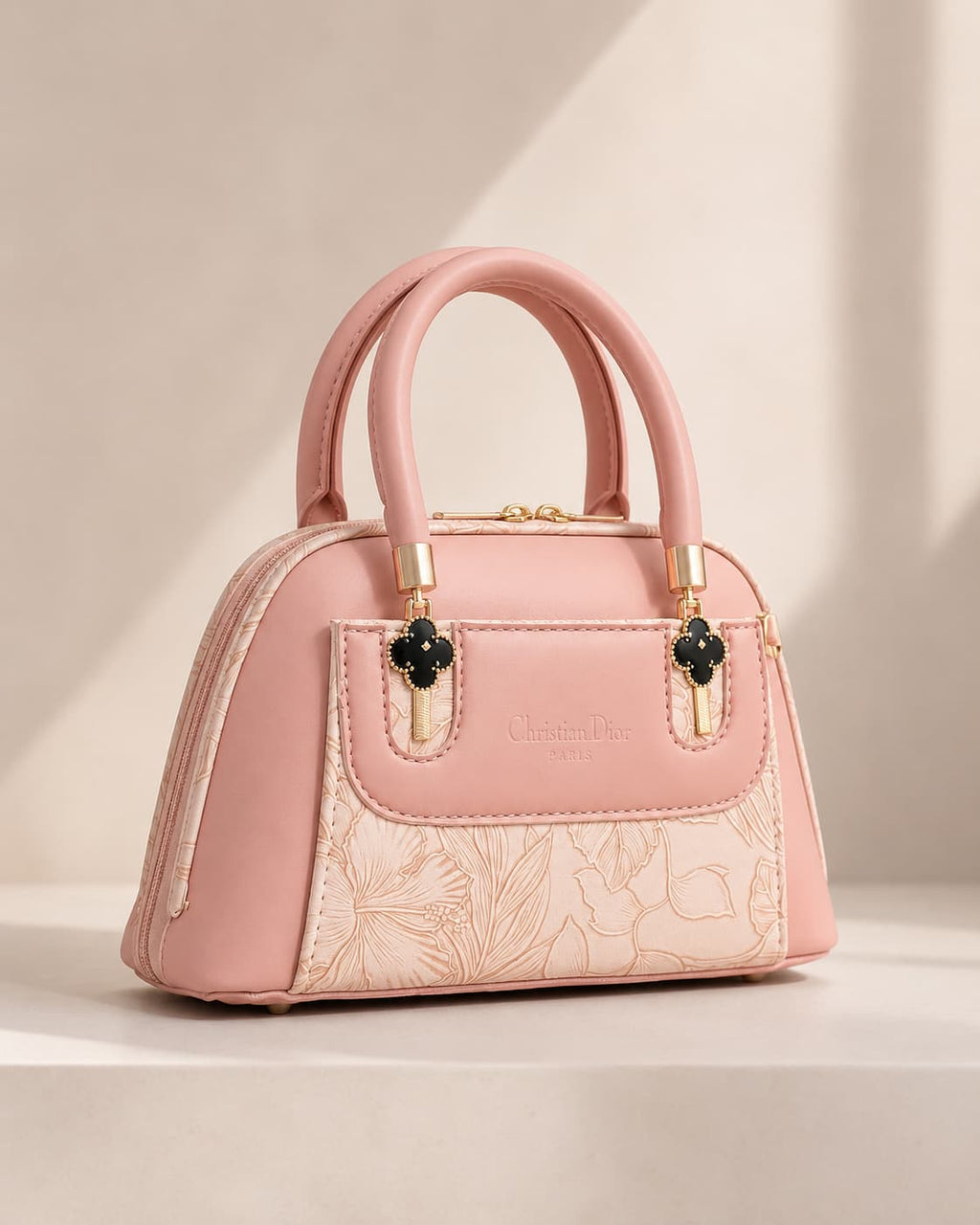 Blush pink rose mini dome bowling bag for women with floral emboss detail gold hardware and clover charm top handle luxury style 2026