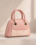 Blush pink rose mini dome bowling bag for women with floral emboss detail gold hardware and clover charm top handle luxury style 2026