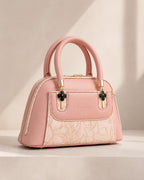 Blush pink rose mini dome bowling bag for women with floral emboss detail gold hardware and clover charm top handle luxury style 2026