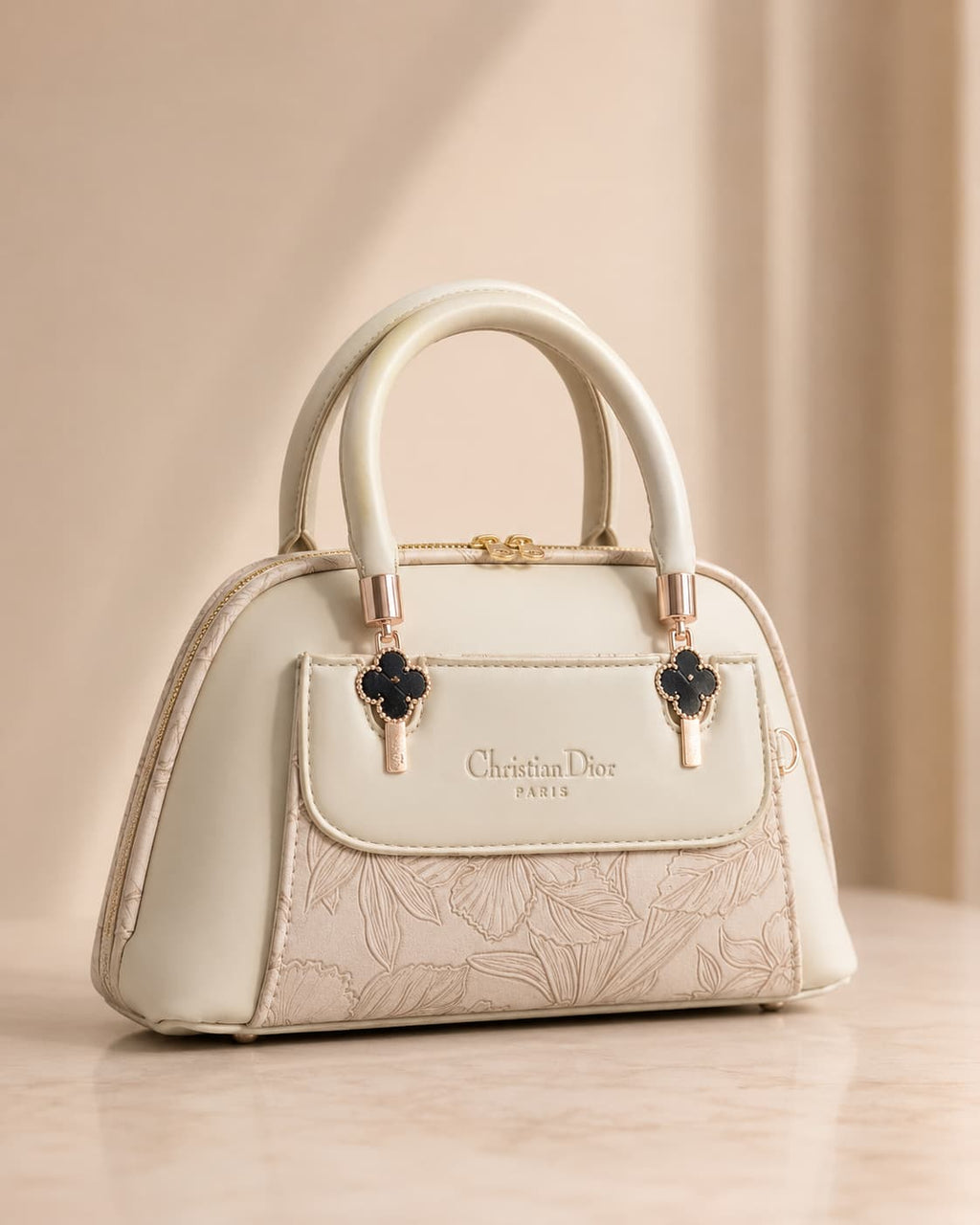 Cream off white mini dome bag for women with floral emboss detail rose gold hardware black clover charm detachable crossbody strap luxury style 2026