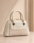 Cream off white mini dome bag for women with floral emboss detail rose gold hardware black clover charm detachable crossbody strap luxury style 2026